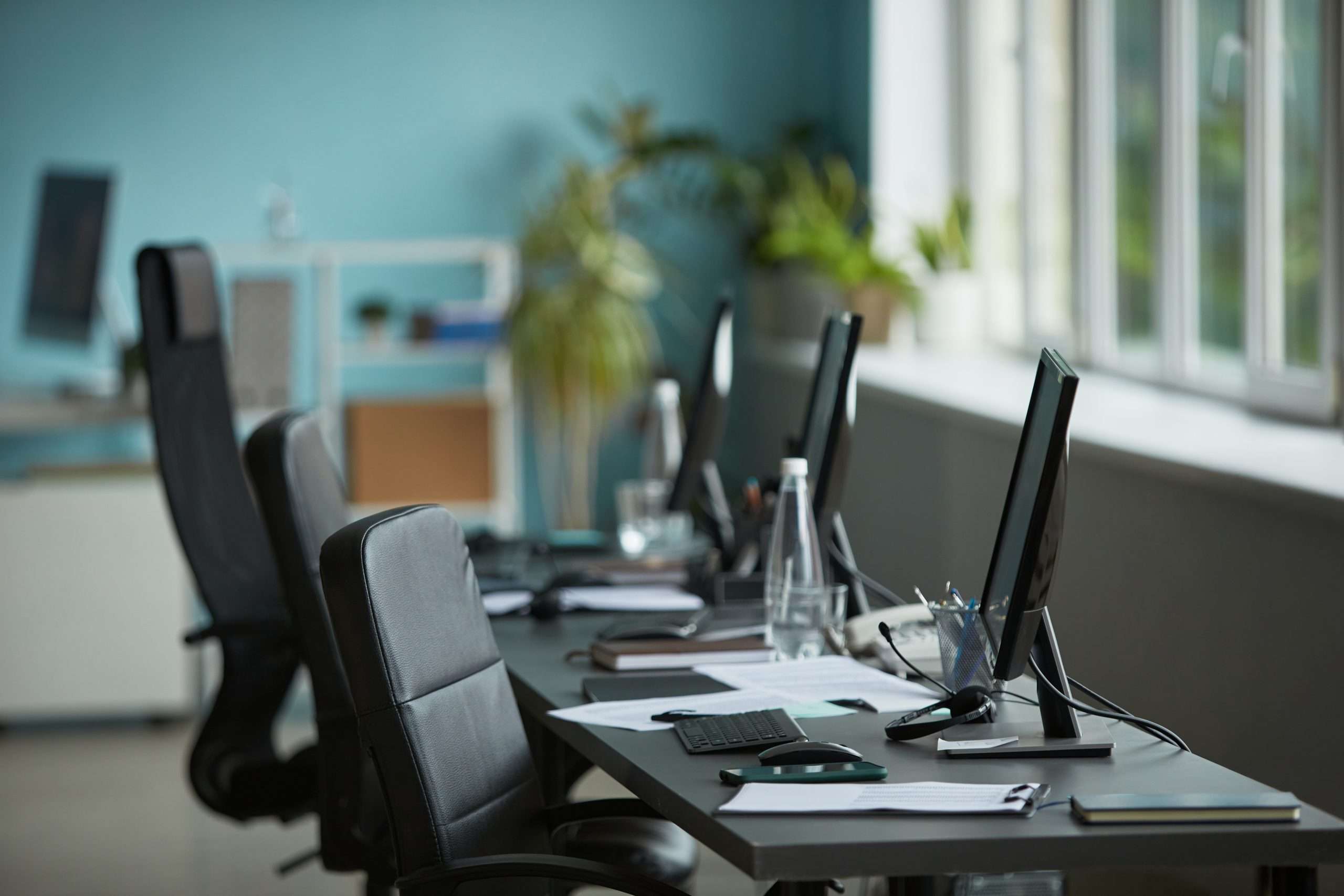 Empty Modern Office Workspace Featuring Computers and Documents on Desk