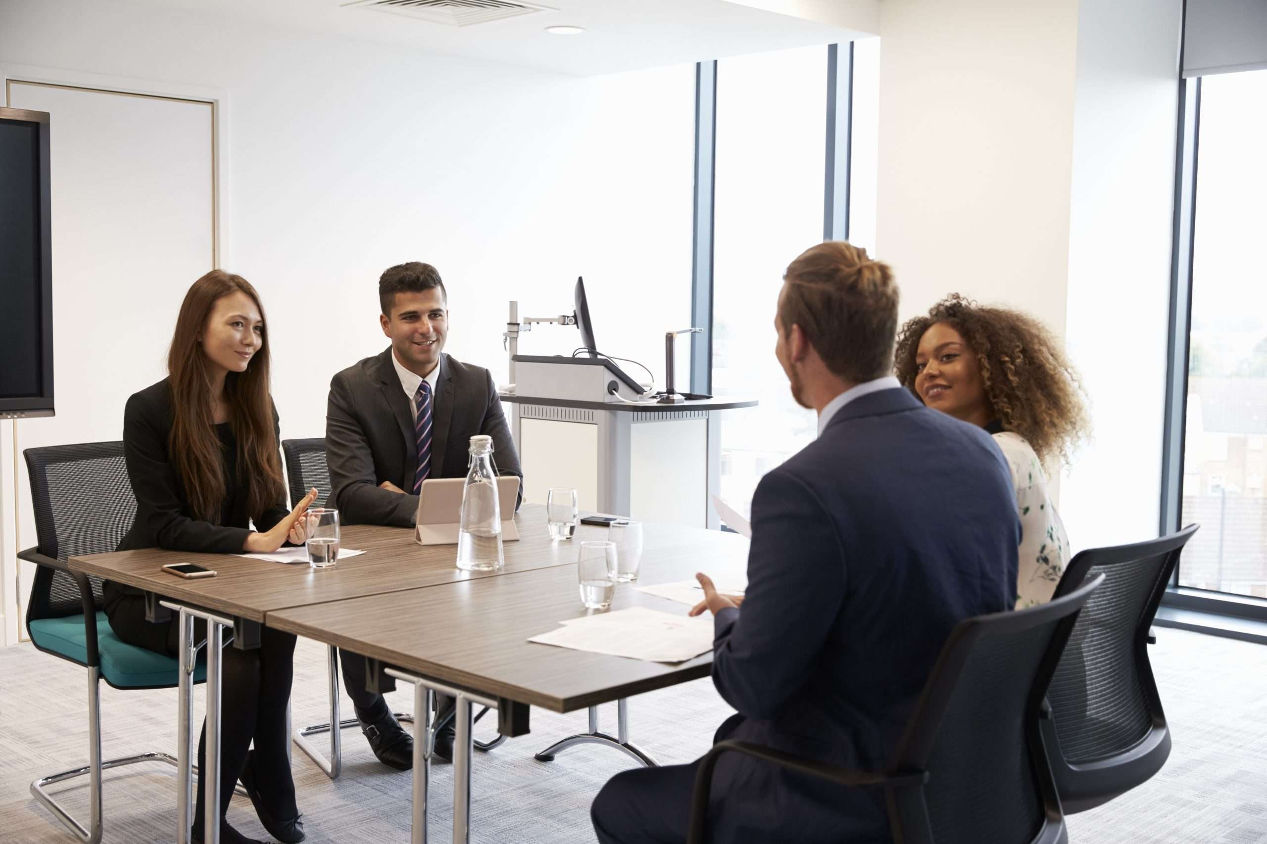 Businesspeople Working Together At Desk In Modern Office