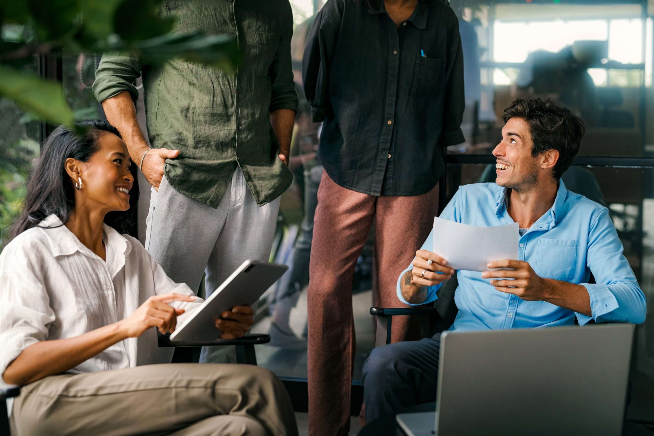 Multicultural professional businesspeople working together on research plan in boardroom.